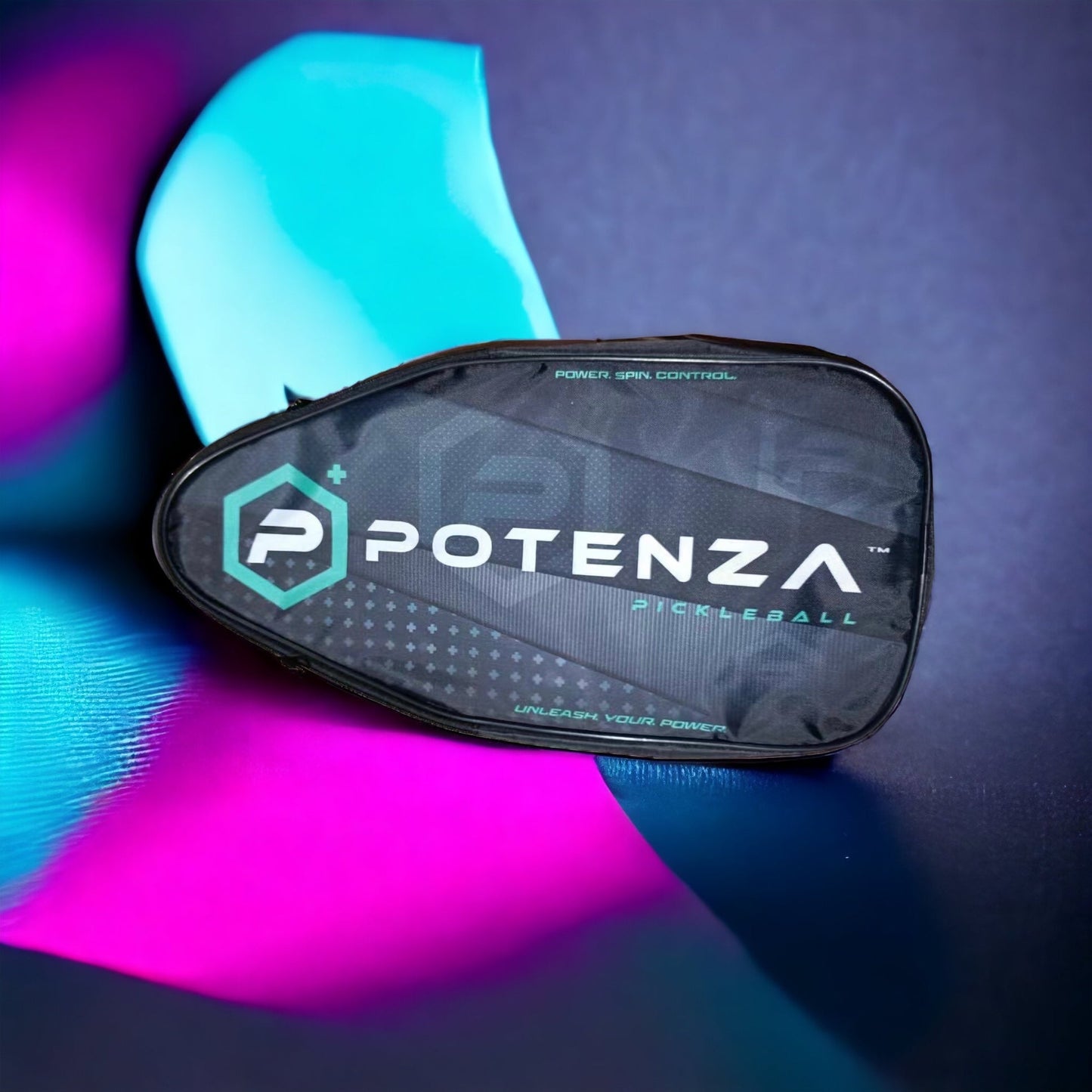 The POTENZA Paddle Travel Case by Potenza Pickleball, designed to hold two paddles, is shown on a dark surface with vivid pink and teal lighting. The sleek black case displays the Potenza logo and geometric design—ideal for travel.