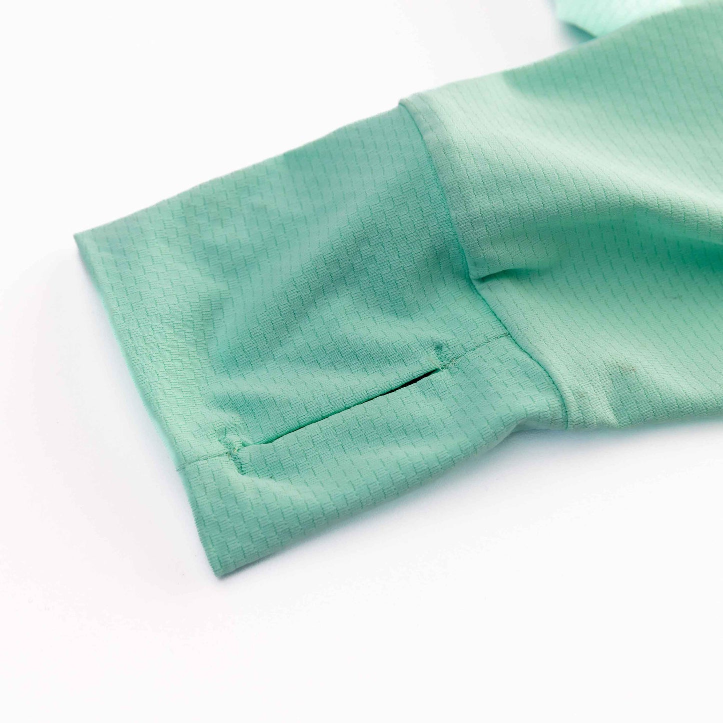 A close-up of the sleeve on the Swinton Pickleball Mint Zip-Front Sun Hoodie, made from lightweight, breathable fabric and offering UPF 50+ protection.