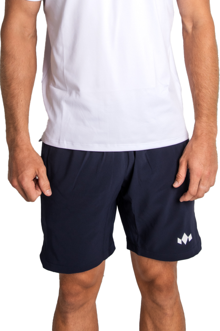 A person wearing a plain white short-sleeve shirt and Diadem Sports Men's Essential 8" Short with a small geometric white logo on the left leg, standing against a white background, visible from torso to upper thighs.