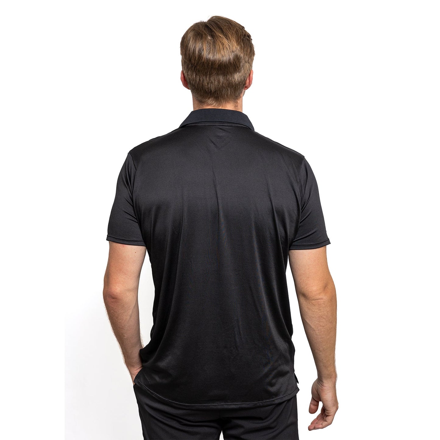 A man wearing the Diadem Sports Men's Essential Polo, which features a sleek performance collar.