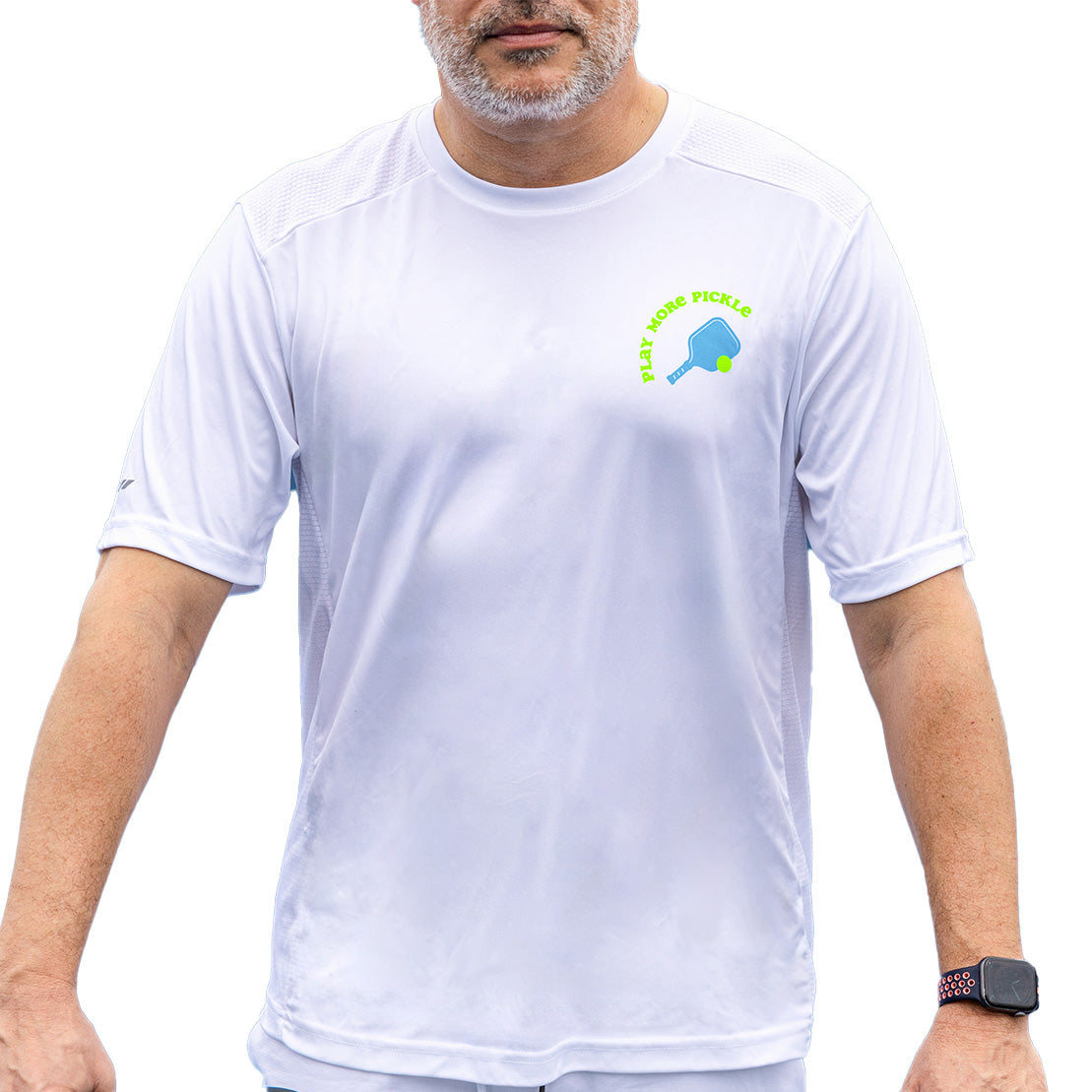 A middle-aged man with a gray beard wears the Men's Pickled 'Em Performance Shirt White by Swinton Pickleball, featuring a blue kiwi bird and green “Lazy Horse Pickles” text. He has a smartwatch and stands against a plain white background.