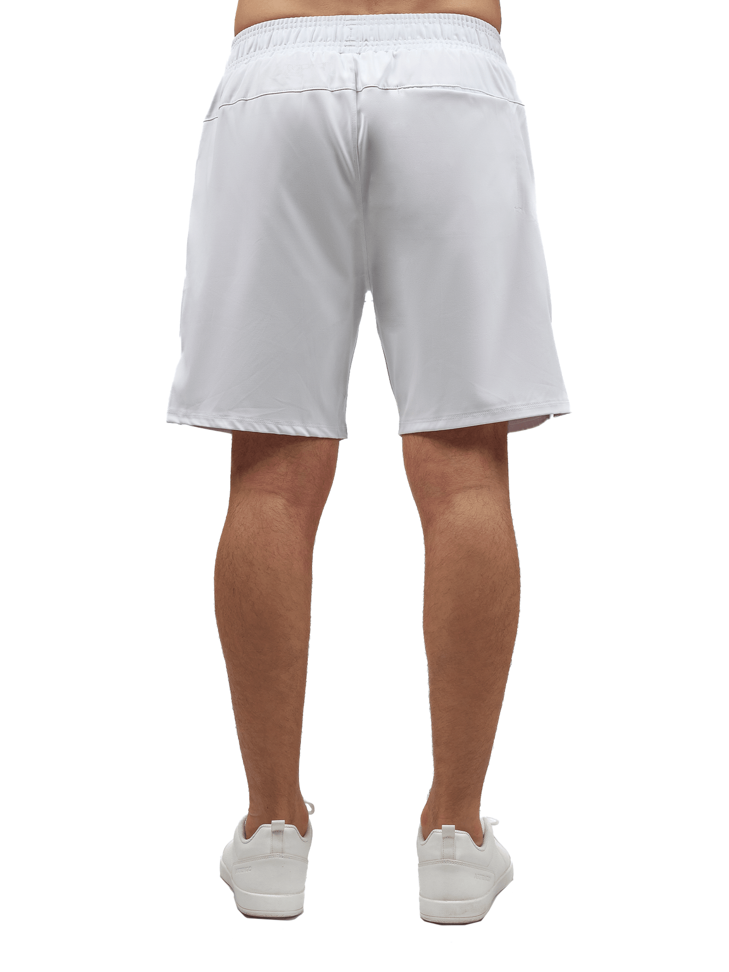 A person faces away, wearing inPhorm NYC Men's Tennis Spin Shorts with Pockets & UV Protection in white and matching sneakers. The knee-length shorts have an elastic waistband, shown from the back against a plain white background.