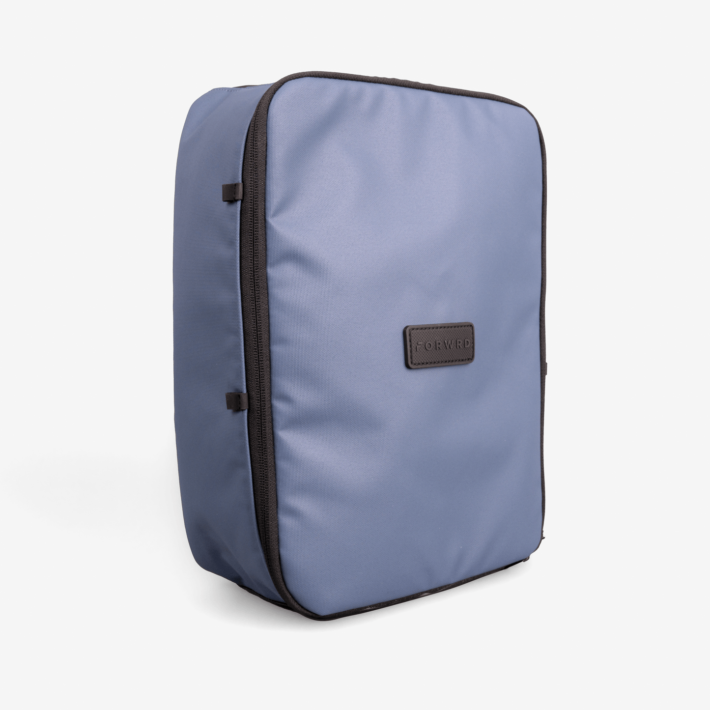 The FORWRD Court Caddy Shoe Cube is a rectangular, blue travel bag with a smooth finish, black zippers on the side and top, and a black patch labeled “FORWRD” on the front. It stands upright against a plain white background.