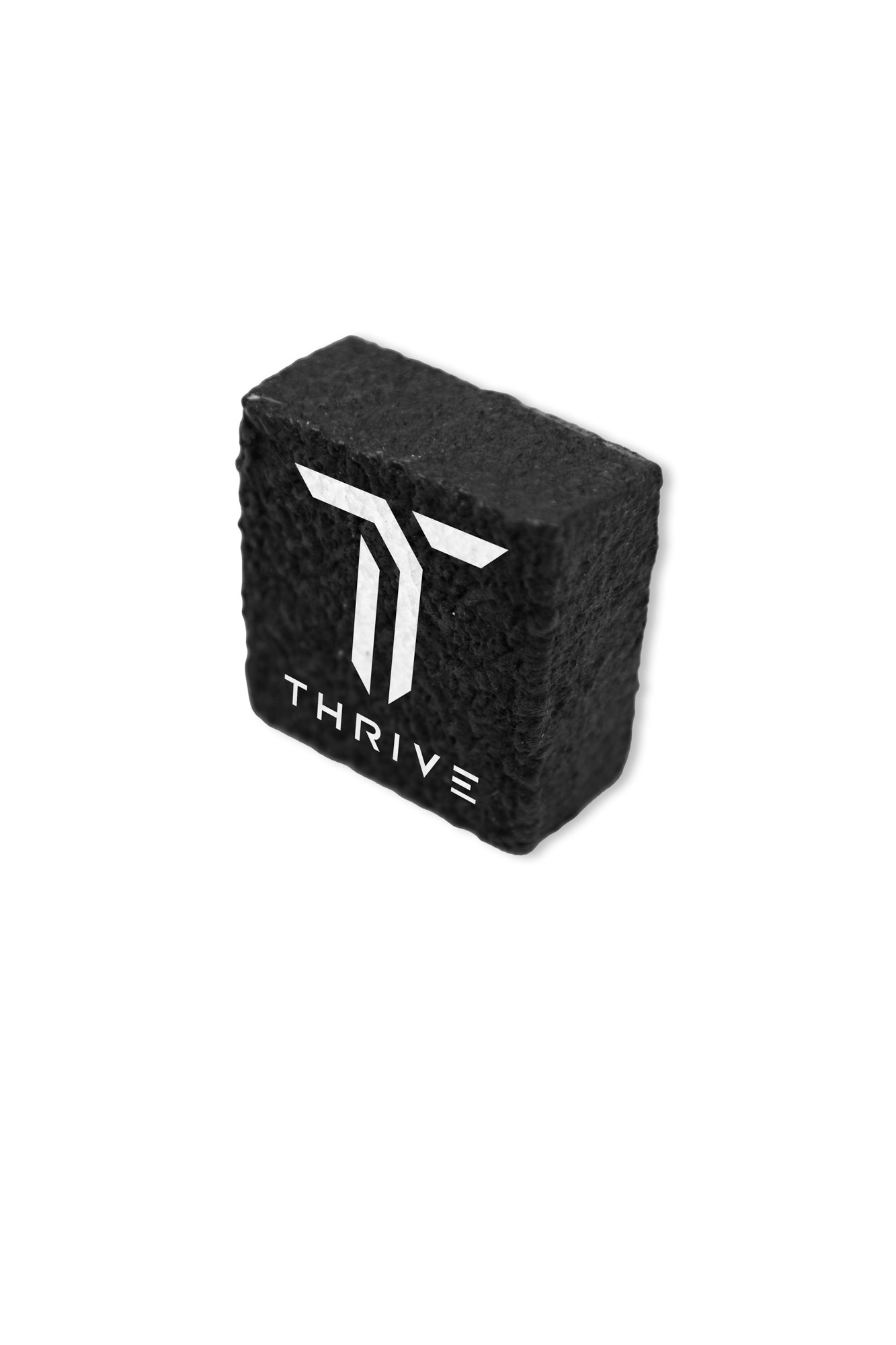 The Paddle Eraser by Thrive Pickleball is a black rectangular eraser with a textured surface and features a white T logo above the word "THRIVE" on the front, perfect for cleaning your carbon fiber paddle.