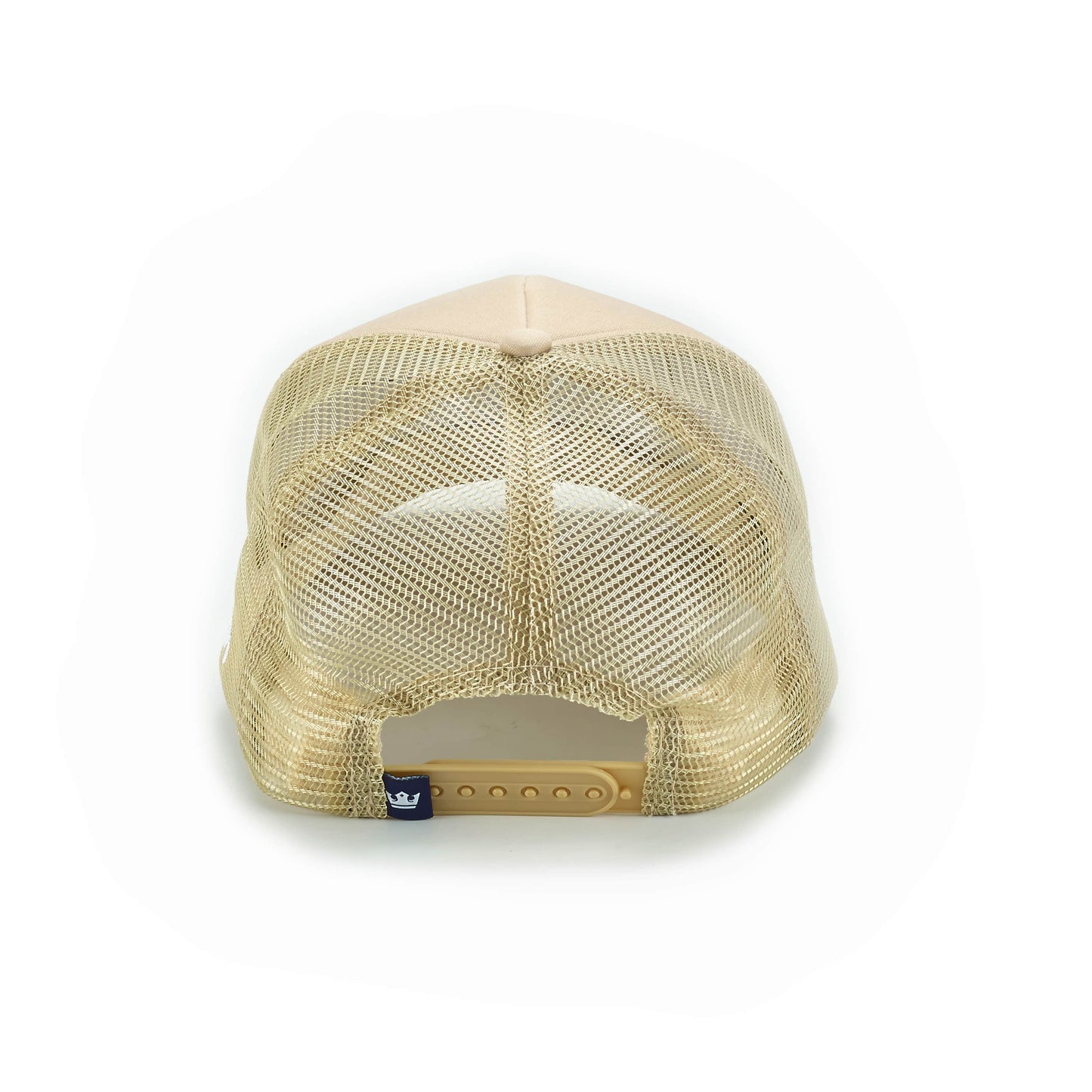 The ARTI Pickle Me Trucker Hat is shown from the back, displaying its solid beige top, see-through mesh back, plastic adjustable snap closure, and a small blue tag on the left—all set against a plain white background.