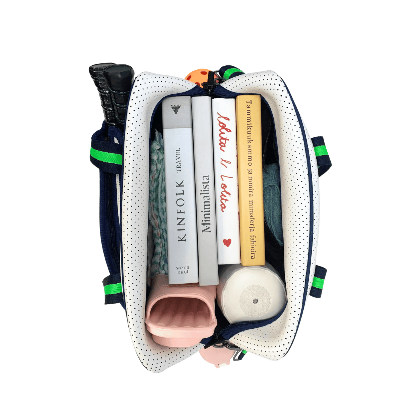 A top view of the PickleballMonger Pickleball Bags White & Green, open to reveal striped handles and neatly packed with three books, a pink water bottle, a white-capped bottle, and a possible folded umbrella against a plain white background.