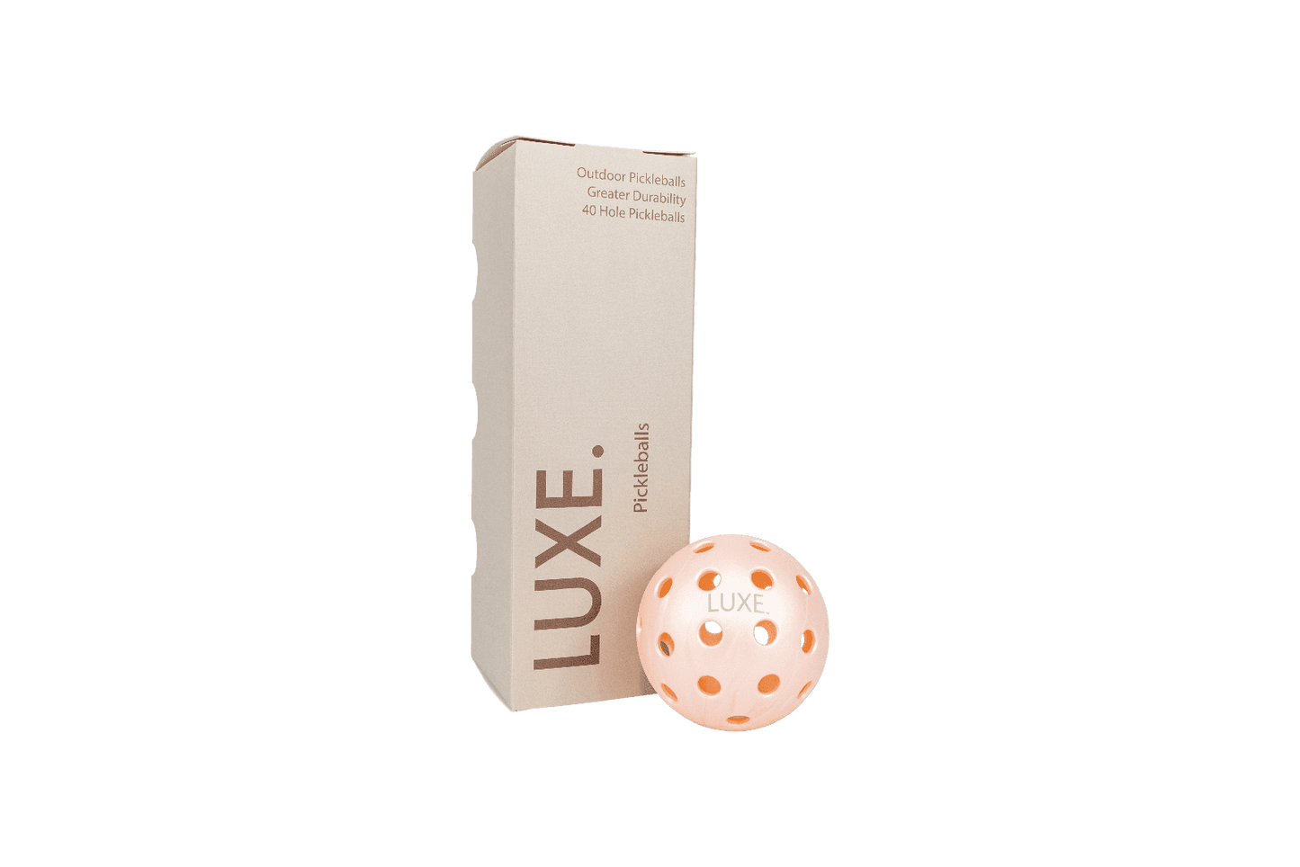 A beige rectangular LUXE Pickleball box stands upright next to a peach-colored, high-visibility pickleball marked "LUXE." The packaging highlights durable 40-hole balls for indoor and outdoor play, ideal for practice or tournaments.