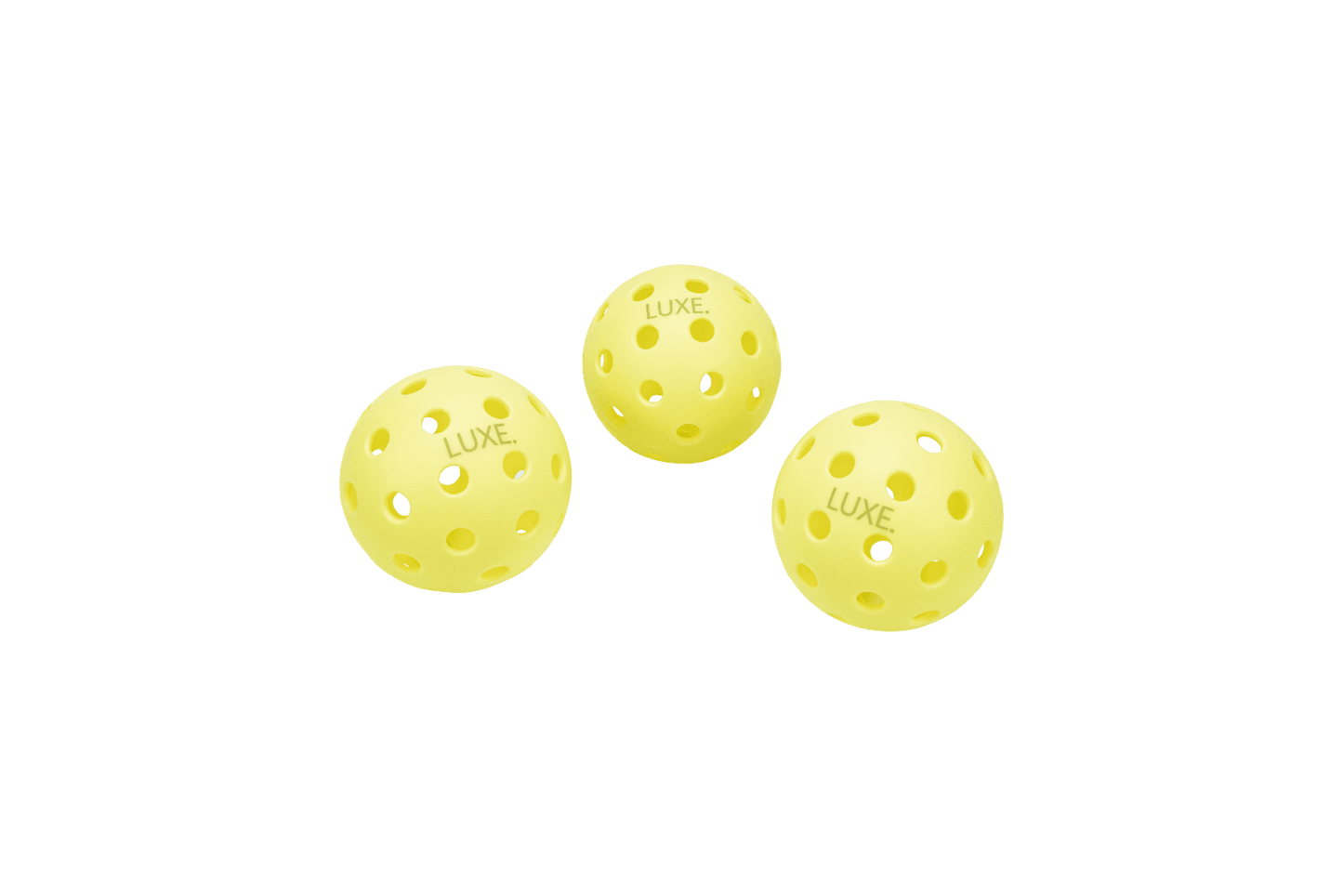Three yellow LUXE Pickleballs by LUXE Pickleball, designed for indoor and outdoor play, are arranged on a white background. Each durable ball features evenly spaced holes and has "LUXE." printed on its surface. Two are in front, one slightly behind.