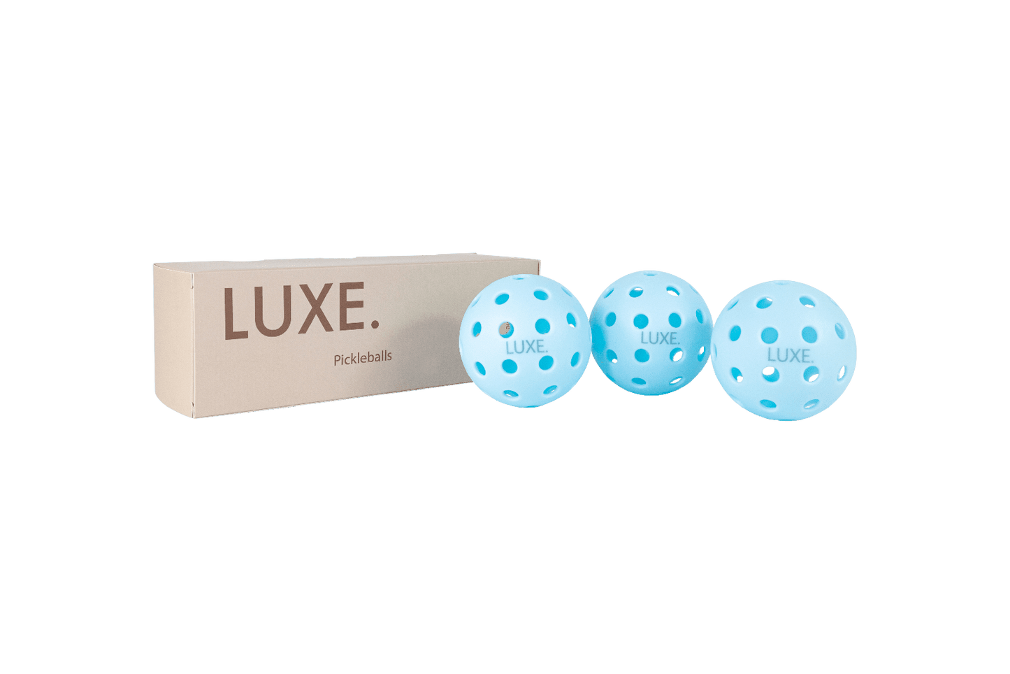 A beige LUXE Pickleball box is next to three high-visibility, light blue LUXE Pickleballs—durable balls for indoor and outdoor play—set against a plain, light gray background.