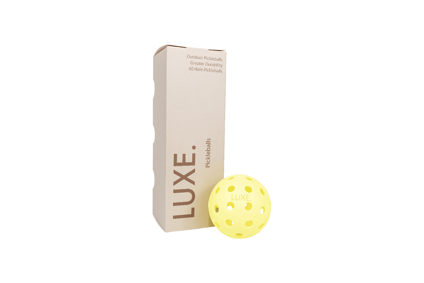 A box labeled LUXE Pickleball stands upright beside a yellow pickleball marked with the brand. The packaging highlights LUXE Pickleballs as durable balls for indoor and outdoor play, featuring a 40-hole construction.
