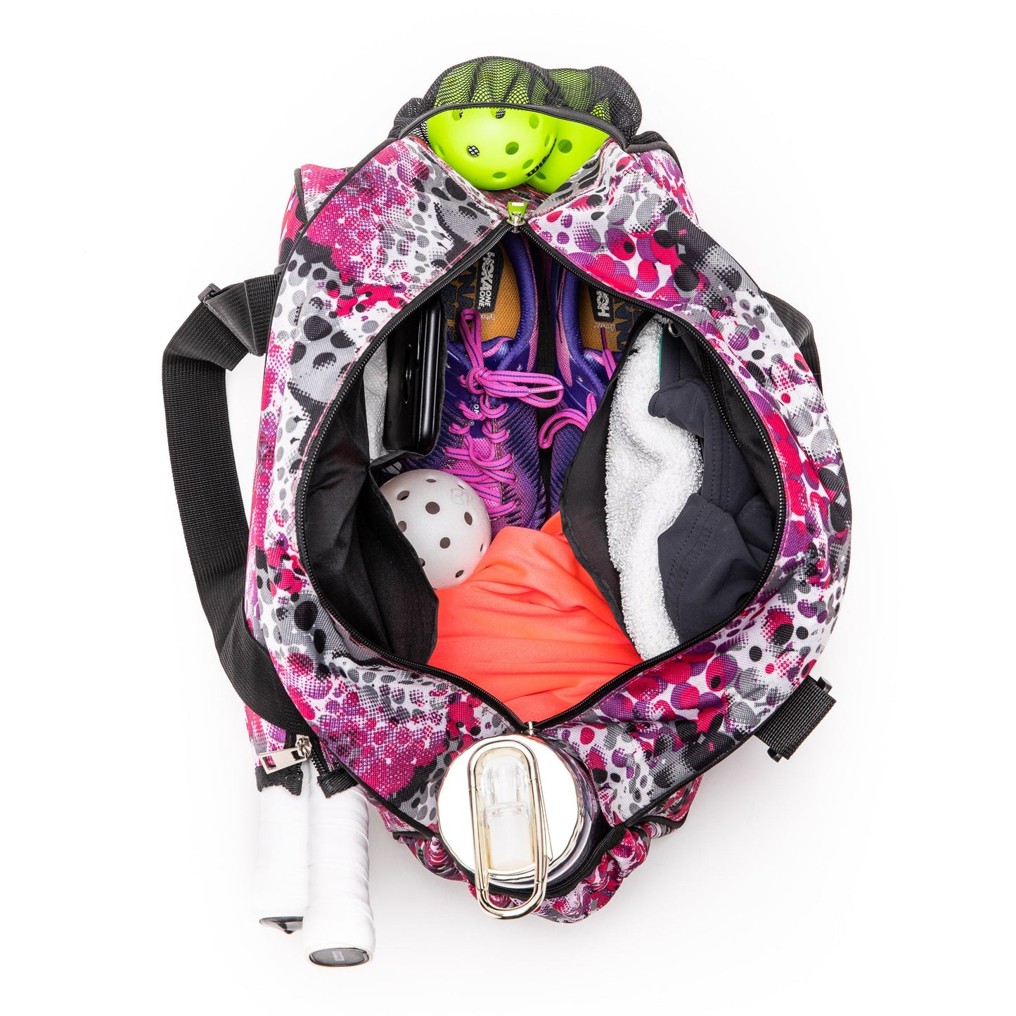 A top-down view of the Pik'le'Ball Sports Stylish Stripe Premium Women's Pickleball Bag, featuring organizer pockets and a carry strap, packed with balls, purple shoes, an orange shirt, towel, and two paddles in the side pocket.