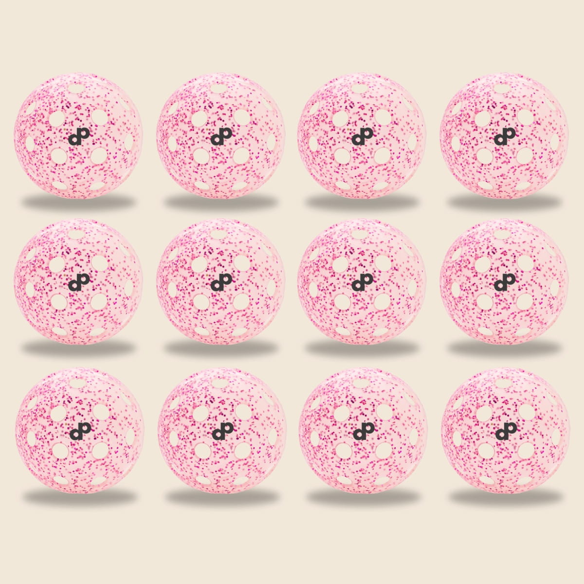 Twelve Pink Glitter-Infused Pickleball Balls by Dope Pickleball Co. are arranged in a 3x4 grid on a light beige background, each casting a small shadow for an evenly spaced and symmetrical display.