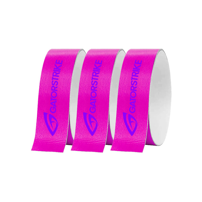 Three rolls of GATORSTRIKE™ Edge Guard Tape - 3 Pack are arranged in a row on a white background. Each bright pink roll, ideal for paddle edge protection, features GATORSTRIKE and a bold blue logo printed along its length.