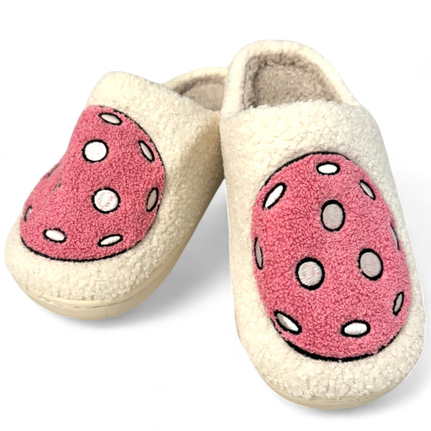 Fresh Pickle’s Pickleball Slippers are cozy cream slippers with large pink oval polka-dot patches, a fluffy texture, soft lining, and closed toes—perfect for lounging or wearing with your favorite pickleball PJs.