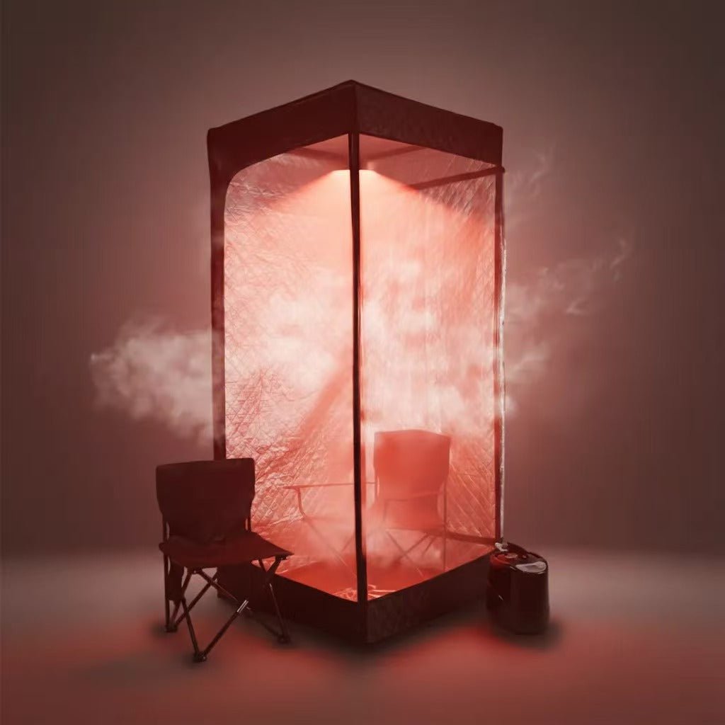 The RevivPro Portable Steam Sauna Box with Steamer features a transparent red-lit enclosure, a folding chair inside, and a black cylindrical steamer that gently fills the space with soothing vapor for relaxing home sessions.