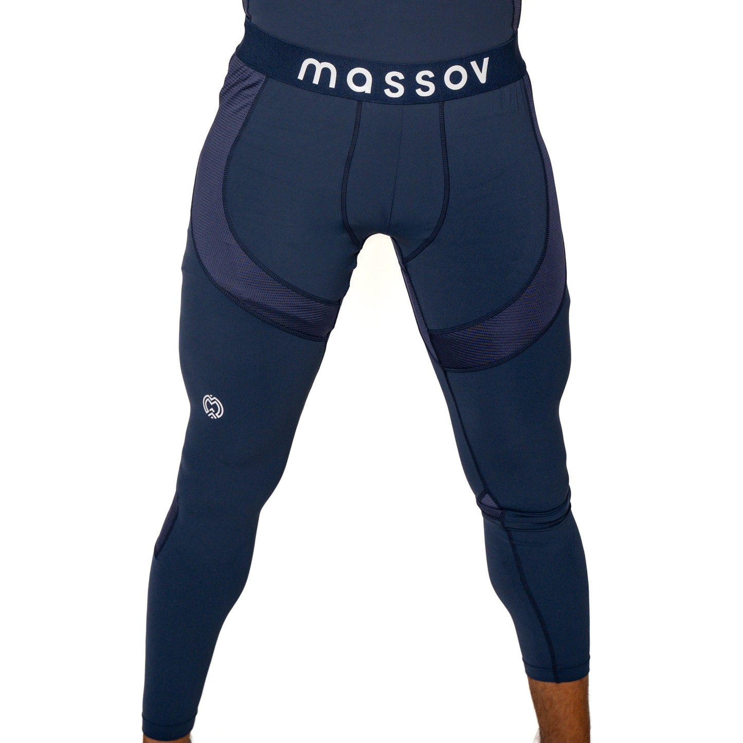 A person wearing tight, navy blue ProForm® Boys' Compression Pants by Massov, featuring mesh panels, visible stitching, a white Massov logo on the waistband, and a small white emblem on the upper left thigh. The background is plain white.