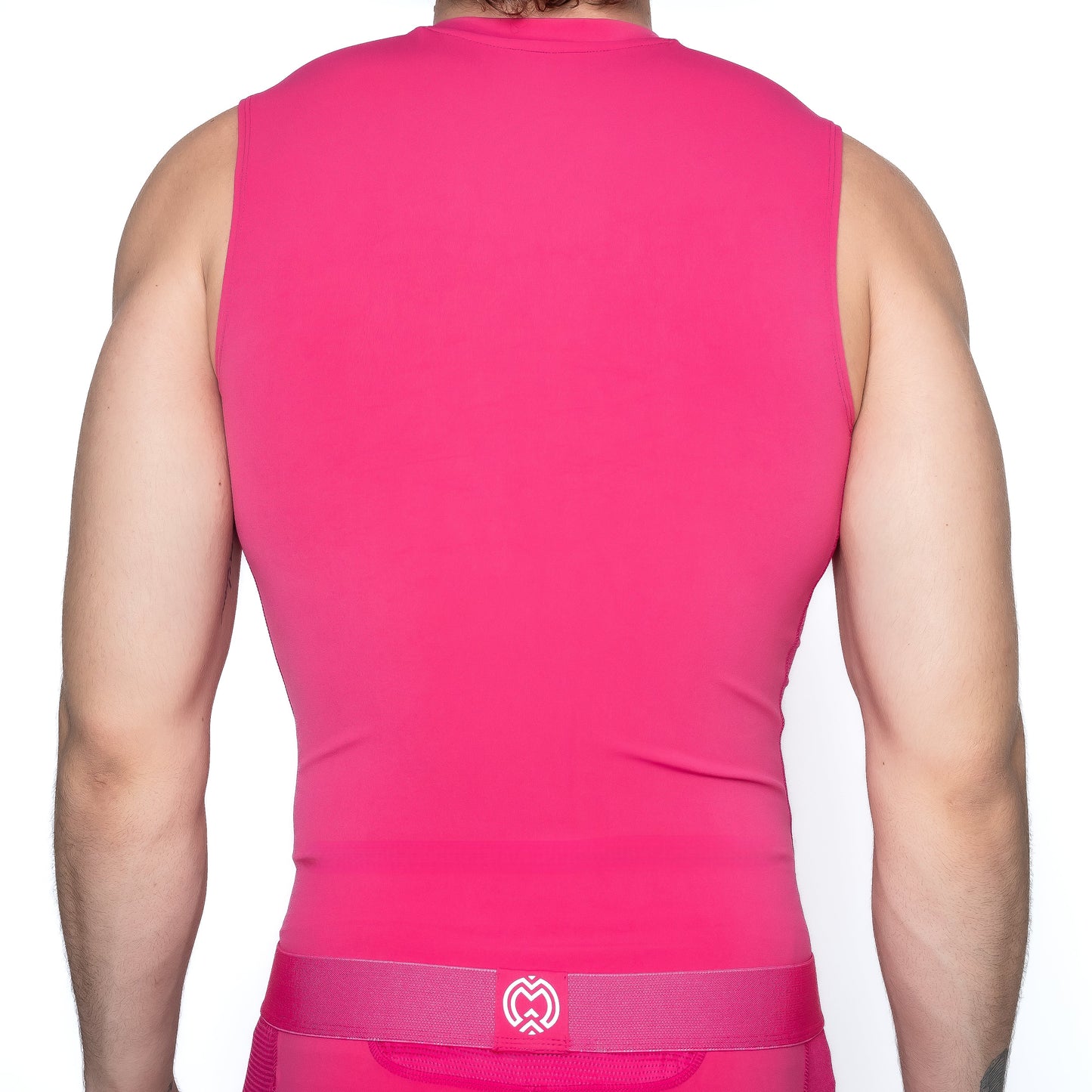 A boy is shown from the back wearing the Massov ProForm® Boys' Compression Tank Top in bright pink with a matching waistband. The fitted top and waistband feature a small white center logo, set against a plain white background.