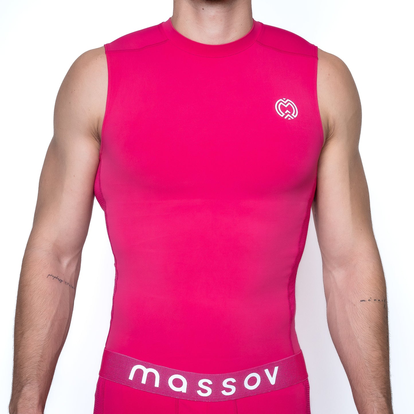 A boy wears a bright pink Massov ProForm® Boys' Compression Tank Top with a white heart logo on the chest and matching pink bottoms featuring "massov" in bold on the waistband, shown from shoulders to hips against a white background.