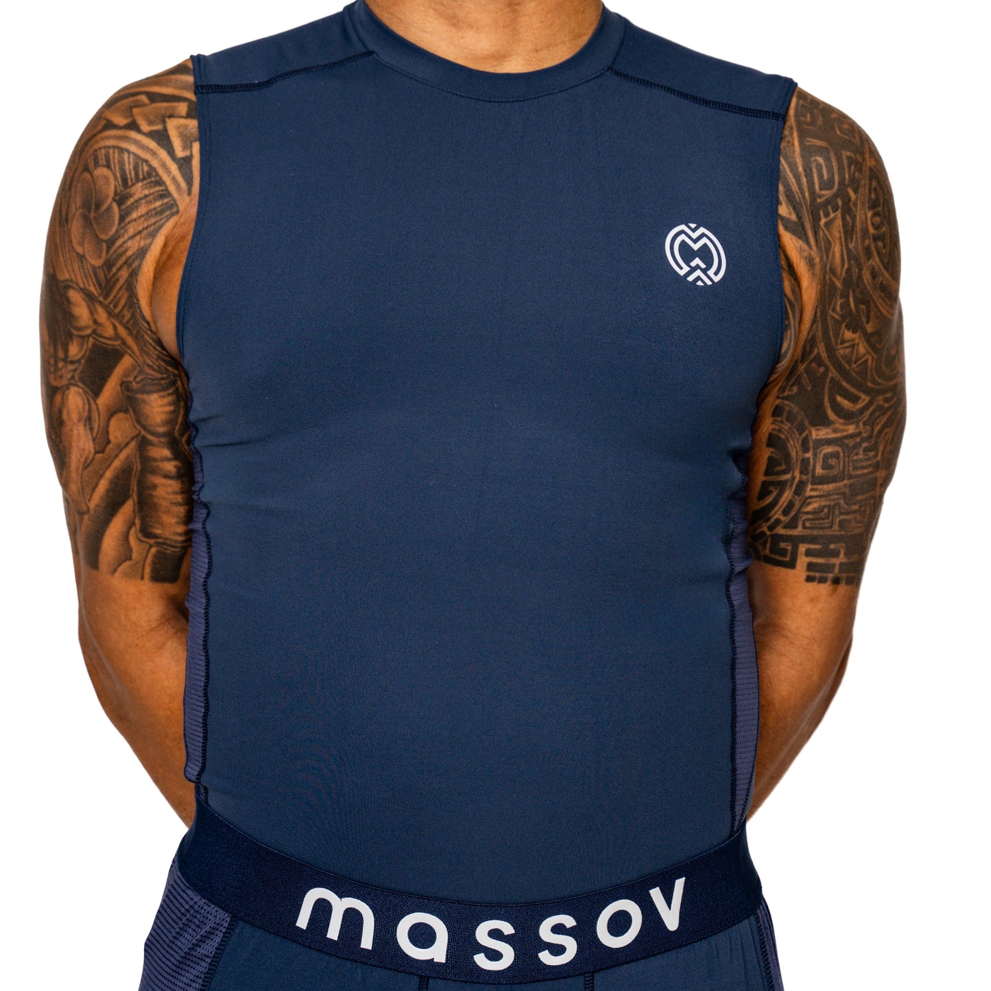A person wears the Massov ProForm® Boys' Compression Tank Top with a small white logo on the left chest and "massov" on the waistband, showing muscular, tattooed arms against a white background—their face not visible.