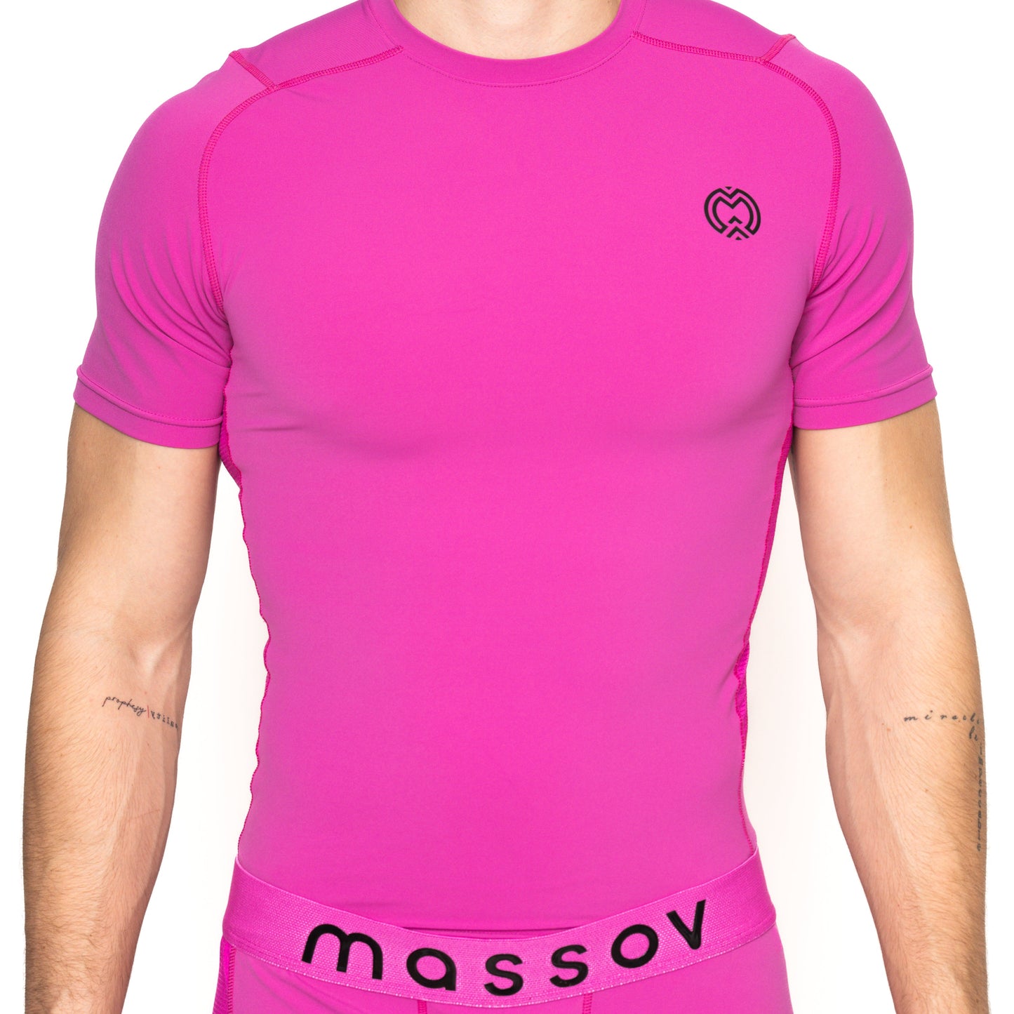 A bright pink Massov ProForm® Boys' Short Sleeve Compression Shirt pairs with matching underwear, featuring a bold “massov” waistband and a small black logo on the top. Only the torso is visible.
