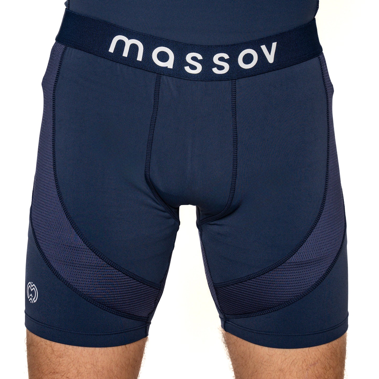 Close-up of a person wearing Massov ProForm® Men’s 7″ Compression Shorts in navy blue, featuring a dark waistband with "massov" in white, subtle mesh patterning on the sides, and a small white logo on the left leg.