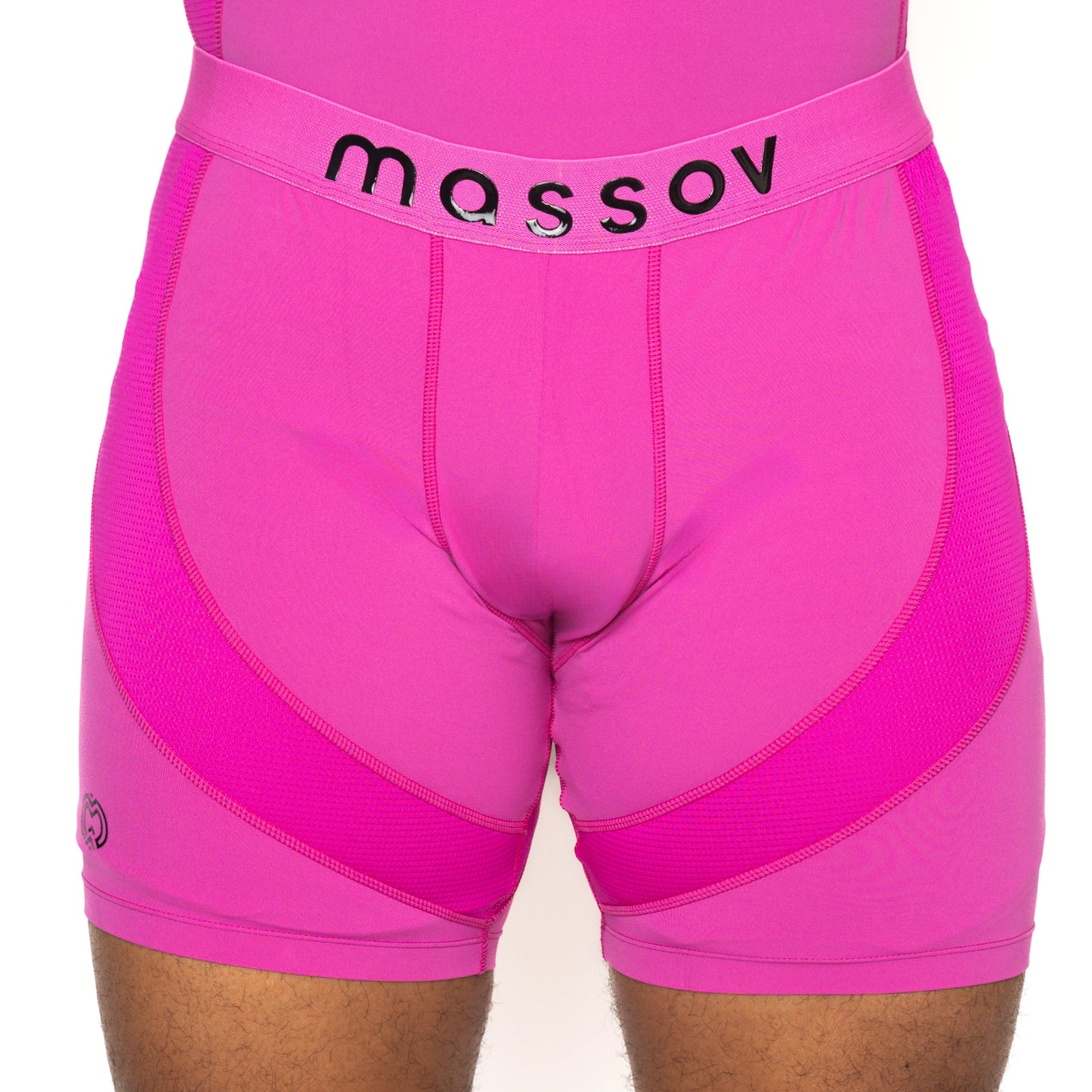 A person wears bright pink Massov ProForm® Men’s 7″ Compression Shorts, featuring mesh-like panels, detailed stitching, and a black "massov" waistband. Only the torso and upper thighs are visible against a white background.