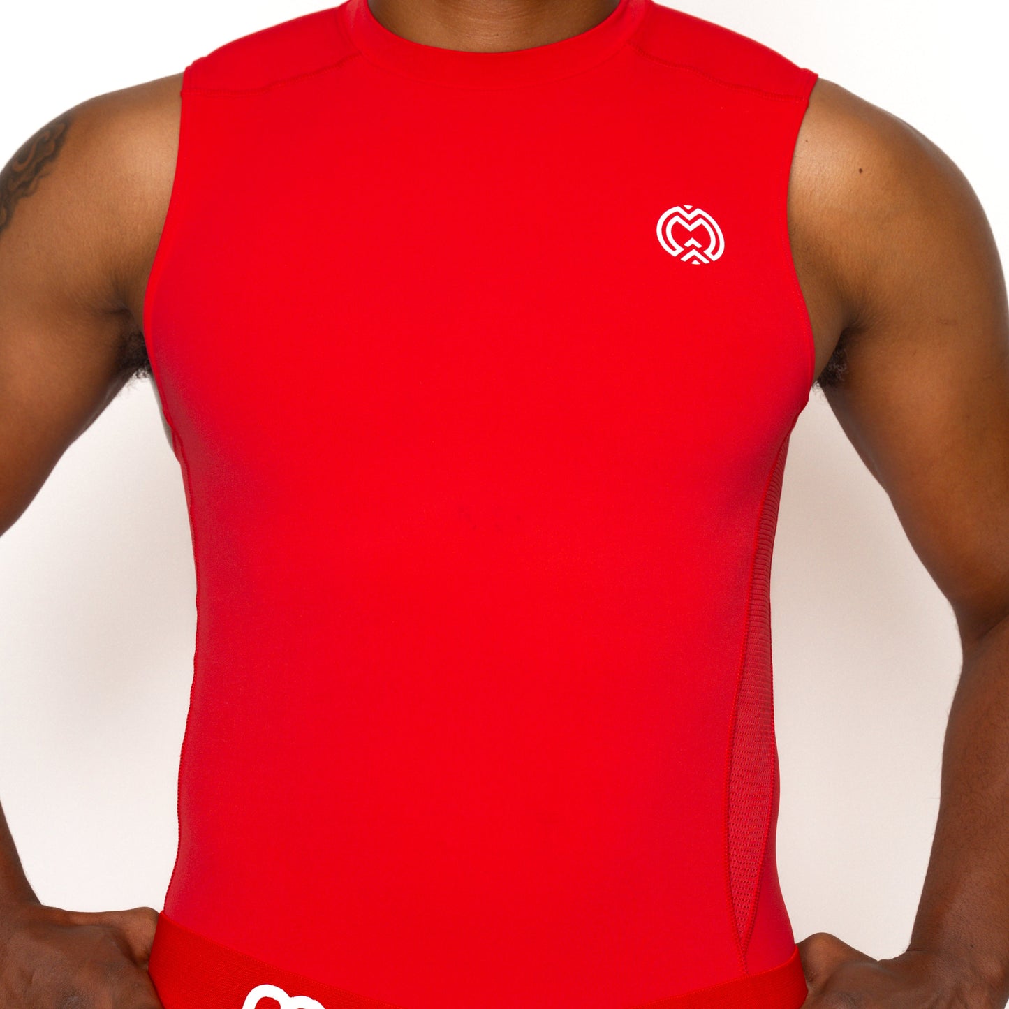 A person wearing the Massov ProForm® Men's Compression Tank Top in red, with a small white heart-shaped logo on the chest, stands against a plain white background. Only their torso and arms are visible.