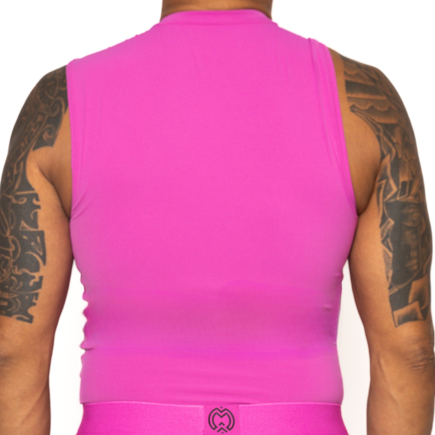 A tattooed person is seen from behind wearing the Massov ProForm® Men's Compression Tank Top in bright pink, featuring a fitted design, high neckline, and logo at the waistband, set against a plain white background.