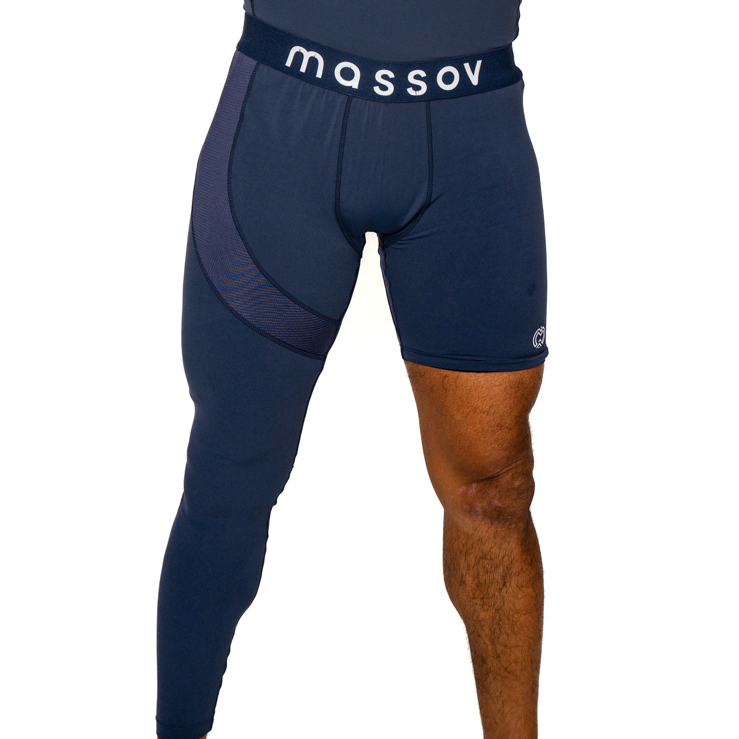 A person wears Massov ProForm® Men's One Leg Compression Pants in dark blue, featuring a compression short on the right leg and a full-length tight on the left. Only the lower torso and legs are shown against a white background.
