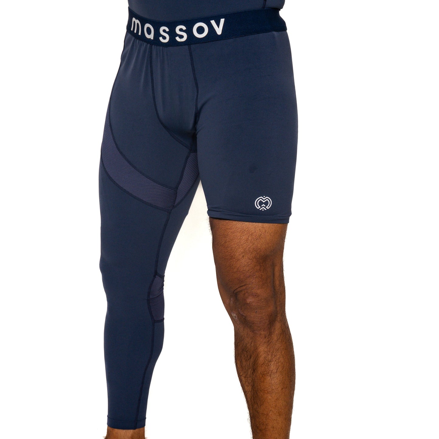 A person wears Massov ProForm® Men's One Leg Compression Pants—navy blue shorts with an attached left compression tight, "MASSOV" on the waistband, a white logo on the lower right leg, and a plain white background.