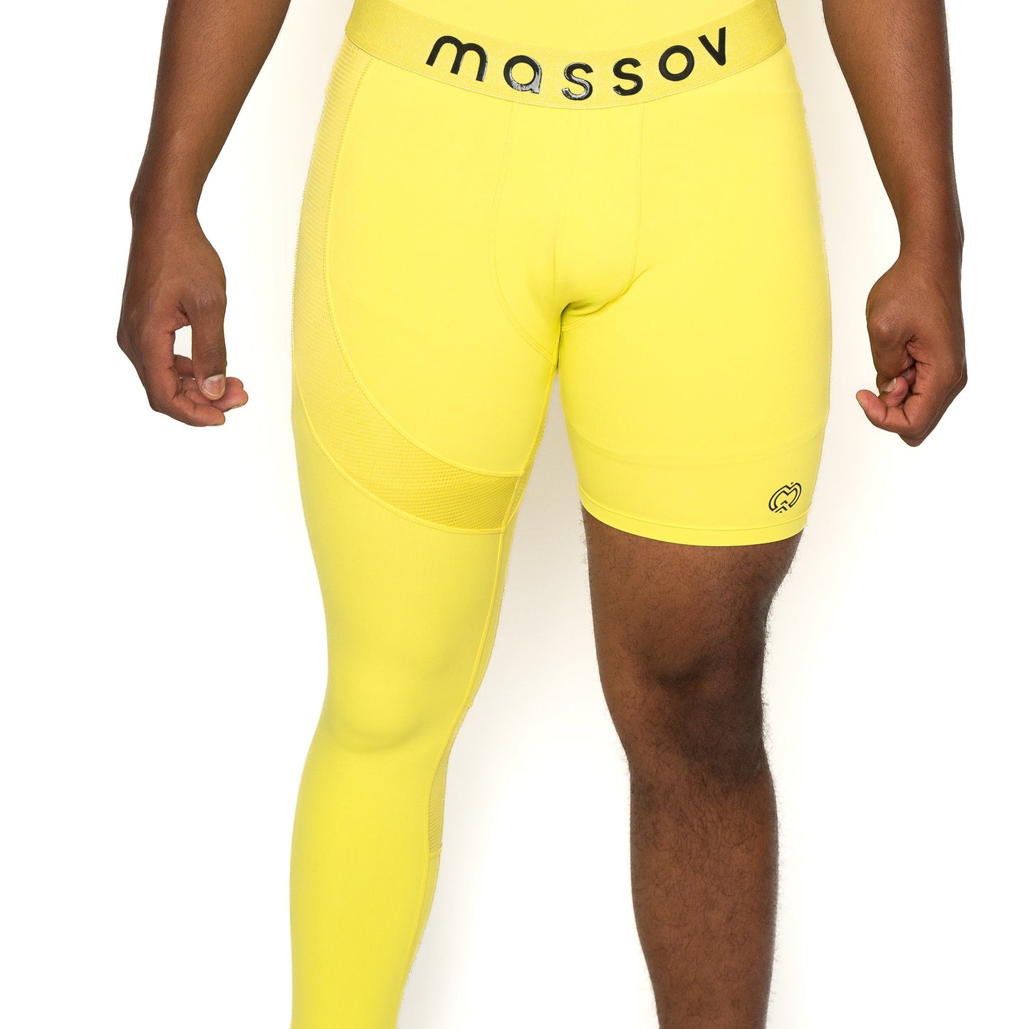 A person wears Massov ProForm® Men’s One Leg Compression Pants—bright yellow with one full leg, one short leg, and a branded waistband—shown on a white background featuring only the lower torso and upper legs.