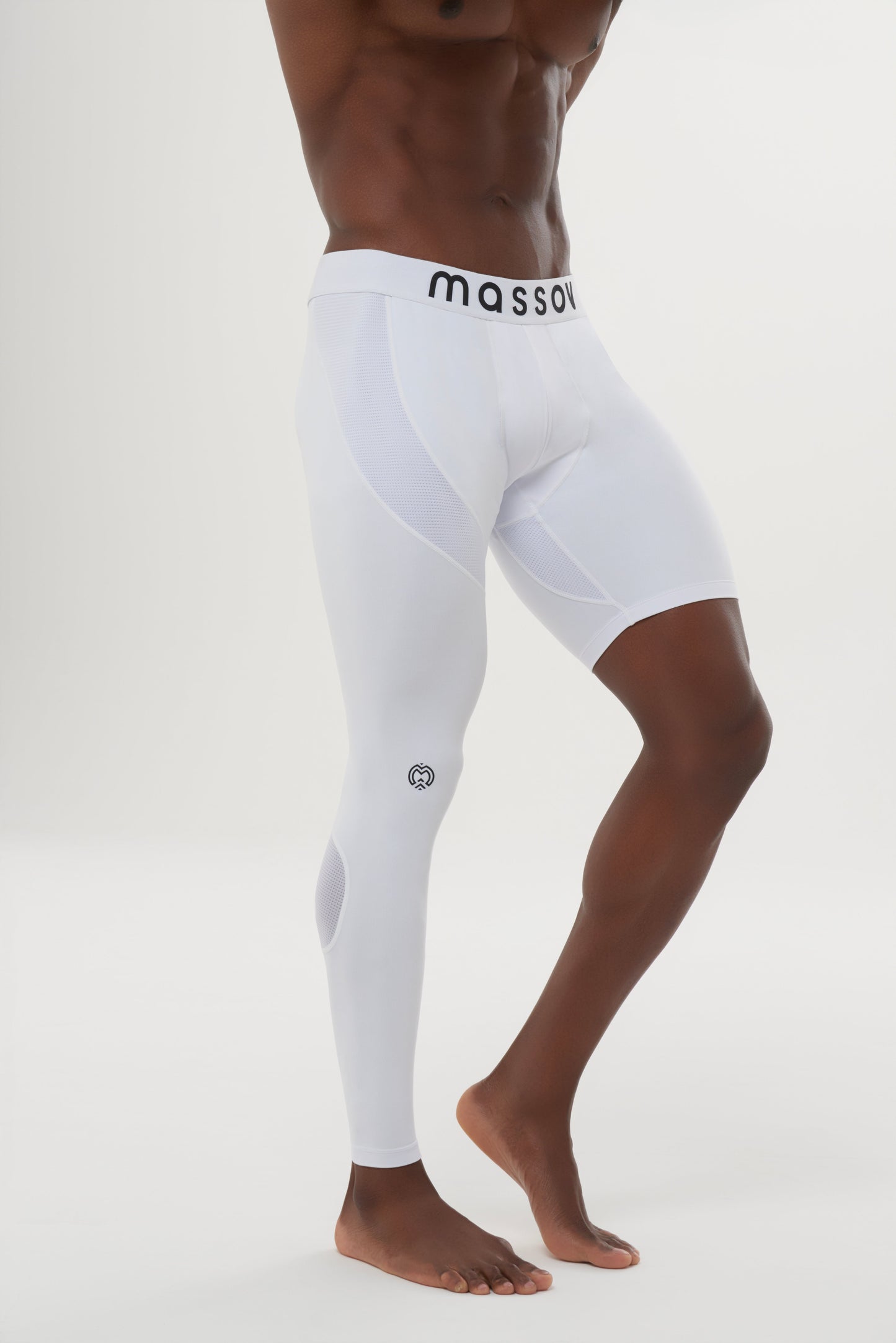 A muscular youth model wears Massov ProForm® Youth Boys' One Leg Compression Pants—white with one full-length right leg and one shorts-length left leg. Barefoot, he poses against a plain white background. The waistband reads "massov.