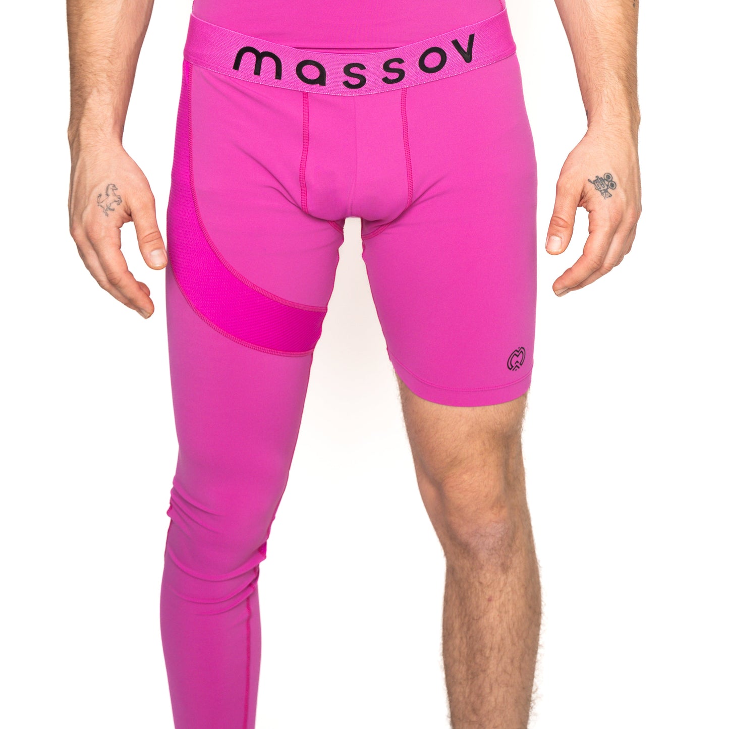 A person wears Massov ProForm® Youth Boys' One Leg Compression Pants—bright pink, with a full left leg and shorts-style right leg. The black waistband reads "massov," and tattoos are visible on both hands.