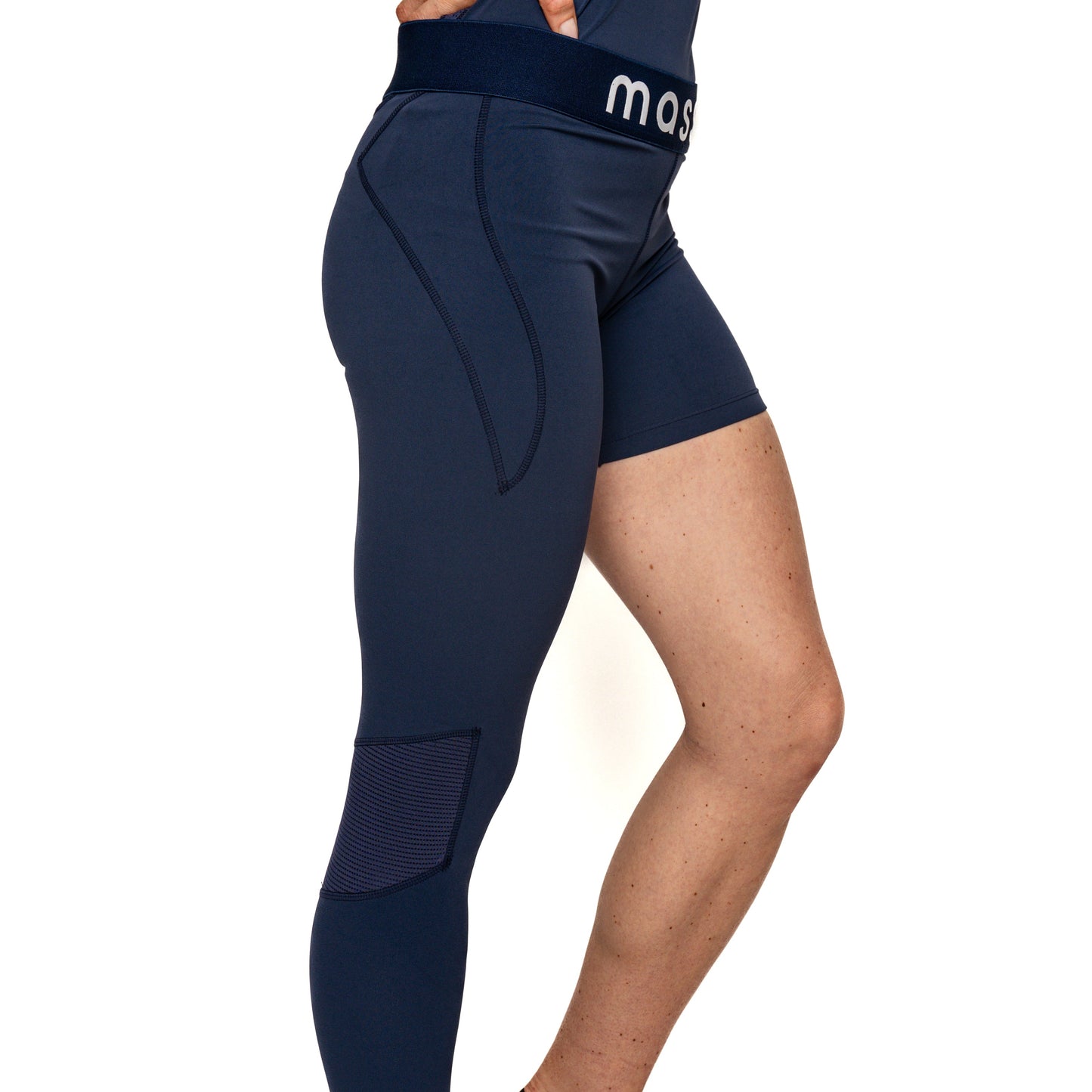 A person with light skin wears Massov's ProForm® Youth Girls' One Leg Compression Pants: one navy leg is a full-length, mid-waisted legging with knee mesh; the other is a biker short. "mas" appears on the waistband. The torso is cropped out.