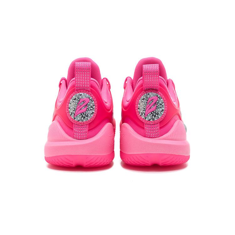 The image shows the back of the Rigorer BP1 'Kaleidoscope' sneakers by BPBazaar in bright pink, featuring a circular heel tab logo with a stylized Z on a silver patterned background, smooth upper, and textured soles.