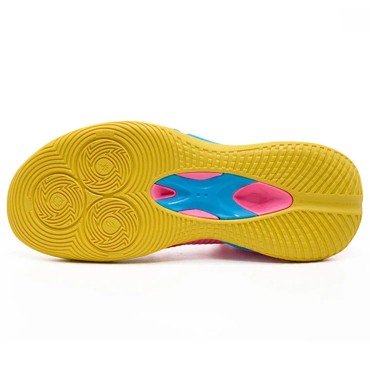A close-up of the BPBazaar Rigorer BP1 “PE” sneaker’s sole shows a bright yellow base with circular grip patterns, a blue midsection, and pink accents. The textured PE outsole enhances traction and stands out with its vibrant, dynamic colors.