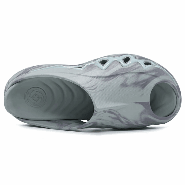A single BPBazaar Rigorer Shark 3 Slides 'Grey' lies on its side, displaying a wavy gray-and-white marbled design, large oval ventilation cutouts, and a textured sole with circular grooves on the footbed.