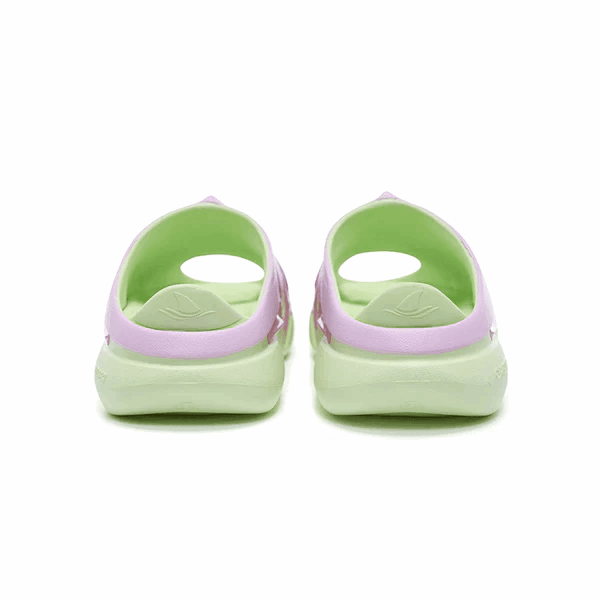 A pair of BPBazaar Rigorer Shark 3 Slides 'Pink/Green' viewed from the back show a light green sole and interior, pastel pink exterior, cutout near the heel, and raised heel design. The background is plain white.