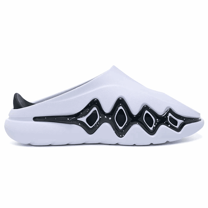 The Rigorer Shark 3 Slides 'White/Black' by BPBazaar feature a modern design with a thick sole, closed toe, and open heel. Their white base showcases a wavy black pattern with small white speckles for a minimalist, futuristic look and all-day comfort.