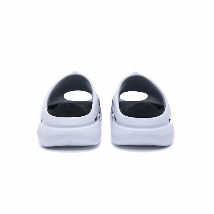 A pair of BPBazaar Rigorer Shark 3 Slides 'White/Black' are shown from the back, highlighting their circular heel cutouts and black insoles, set against a plain white background.