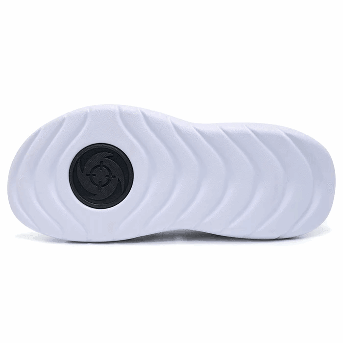 The image shows the white rubber outsole of BPBazaar Rigorer Shark 3 Slides 'White/Black,' featuring wavy grooves and a black geometric circle at the ball of the foot, ideal for athletic sandals.