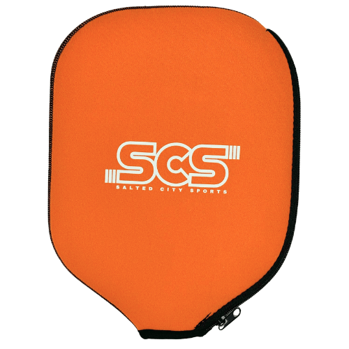 The Salted City Sports Pickleball Paddle Cover features an orange design with a black edge and zipper, plus a bold white SCS logo on the front. Its custom shape offers superior protection for your paddle during storage or travel.