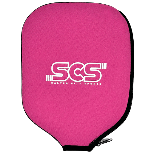 The Salted City Sports Pickleball Paddle Cover features bright pink fabric, a centered white SCS logo, black trim, a rounded shape, and a small bottom-right zipper for easy access and paddle protection.