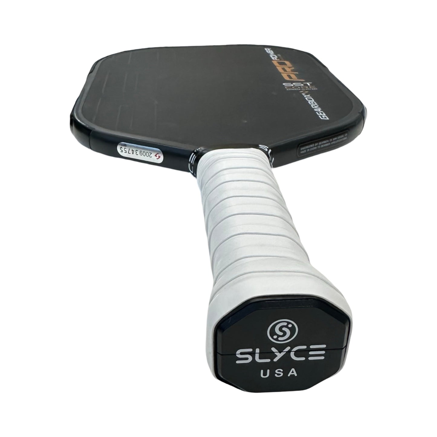 Close-up of a black Slyce Sport paddle with a white-wrapped handle, matte finish, visible Slyce USA logo on the end cap, barcode sticker near the edge, and the SLYCE Gearbox (26g) SpeedCap Paddle Performance Enhancer for improved balance.
