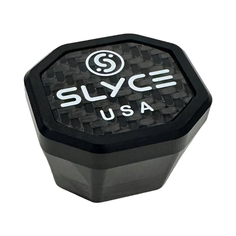 The SLYCE Weighted SpeedCap (15g, 1/2oz.) by Slyce Sport is a black, octagonal paddle performance enhancer with a textured carbon fiber-like surface and bold white Slyce logo, “SLYCE,” and “USA” branding on its face.