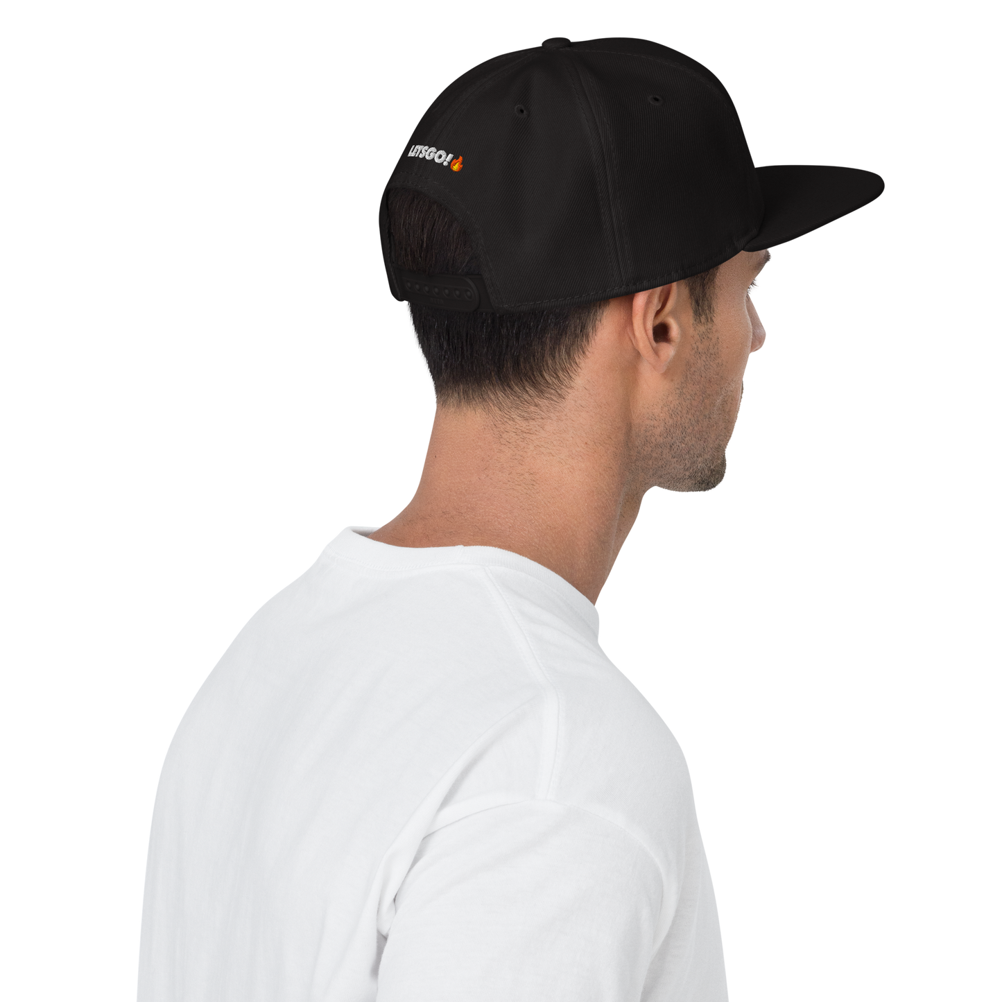 A man in a white t-shirt is seen from behind wearing the Crown Pickleball "Corona" Snap-back Hat in black, featuring an embroidered white and orange logo on the side. The plain light background adds a clean, minimal look.