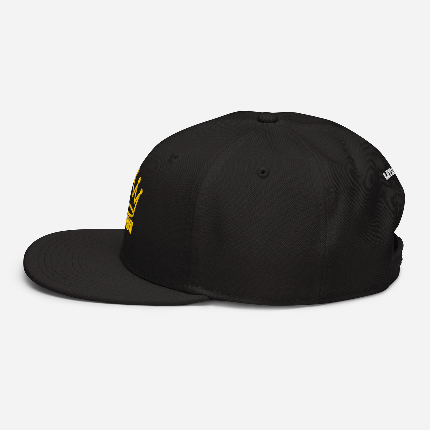 The CROWN PICKLEBALL - Corona Snap-back Hat (Black) by Crown Pickleball is shown in a side view on a white background, featuring a yellow embroidered crown and text on the front left, with a flat snap-back bill and visible stitching.