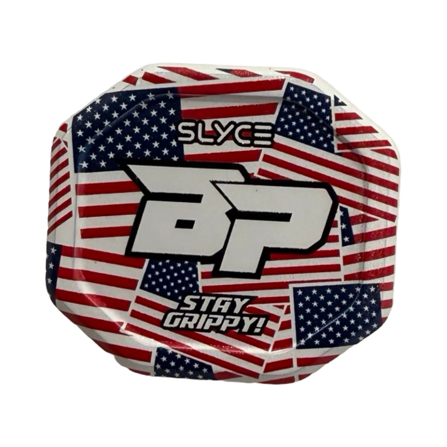 A white octagonal Slyce Sport Patriot SpeedCap (28g, 1.0 oz.) paddle enhancer features overlapping American flags, bold white "AP" in black outline, "SLYCE" above, and "STAY GRIPPY!" below—a patriotic pickleball grip cap.