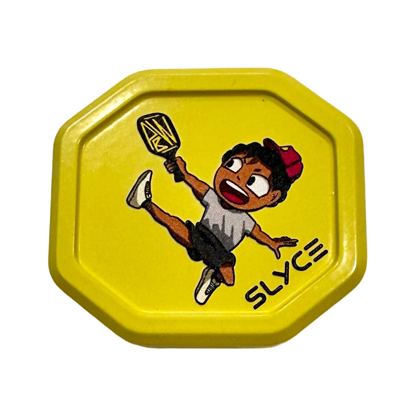 The Special Edition Pickleball Will SpeedCap (28g, 1.0 oz.) by Slyce Sport is a yellow, octagon-shaped grip cap with a cartoon boy in a red cap jumping with a pickleball paddle. "SLYCE" appears in black at the bottom right on a white background.