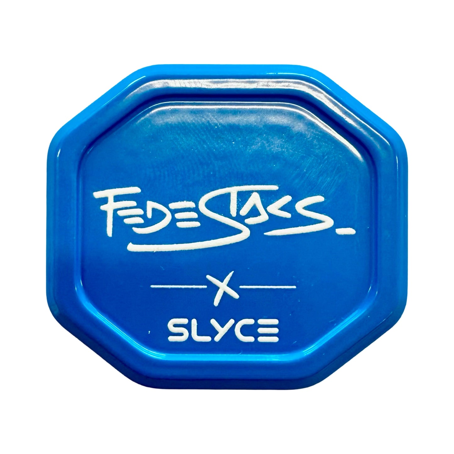 A blue, octagonal Slyce Sport grip cap for pickleball paddles features "FedeStacs" above an 'X' and "SLYCE," inspired by the Federico Staksrud SpeedCap. 28g (1.0 oz.), set on a plain white background.